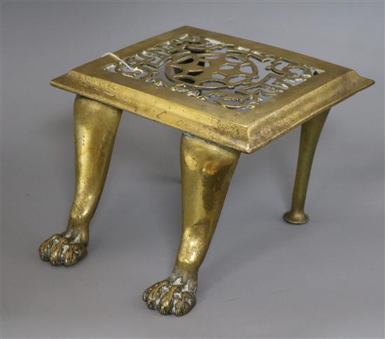 A pierced brass footman with lions paw feet height 18cm